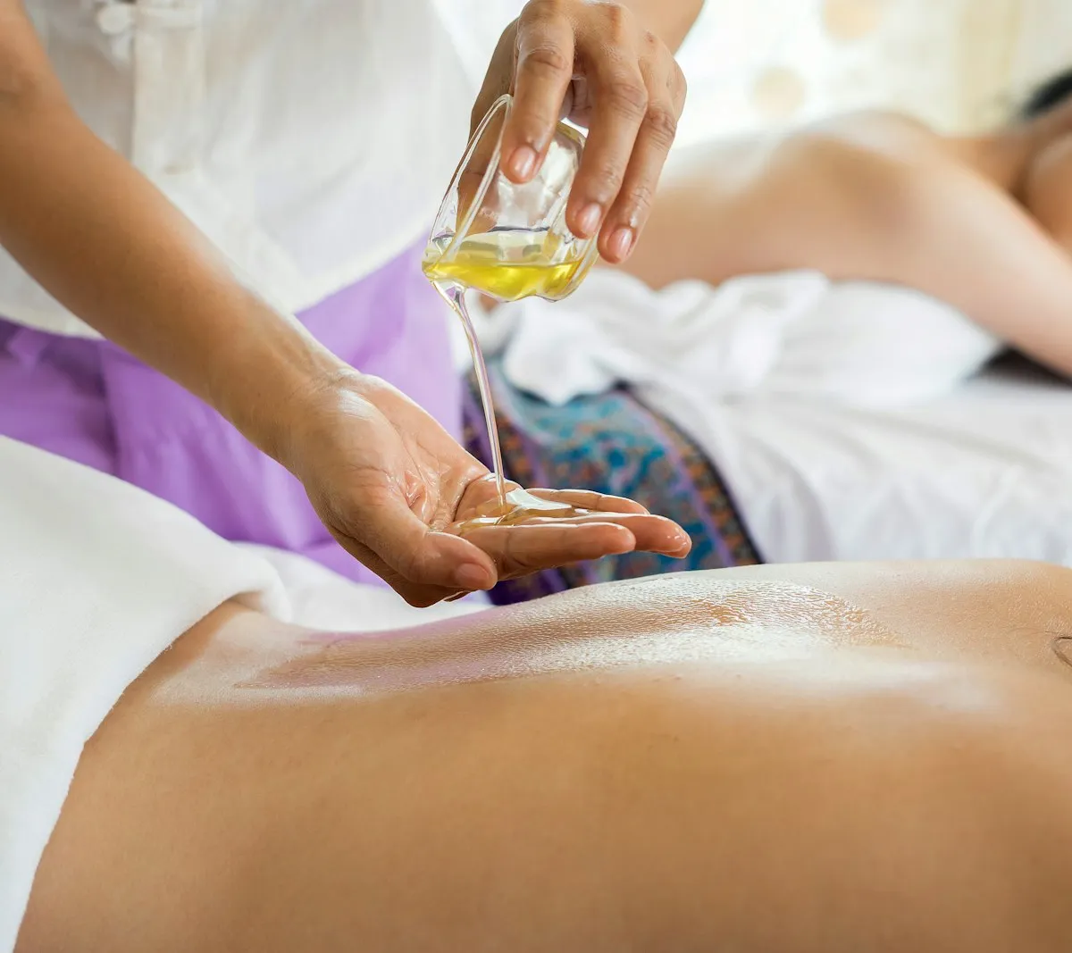 Spa treatment room set for a massage session, facing the ocean
