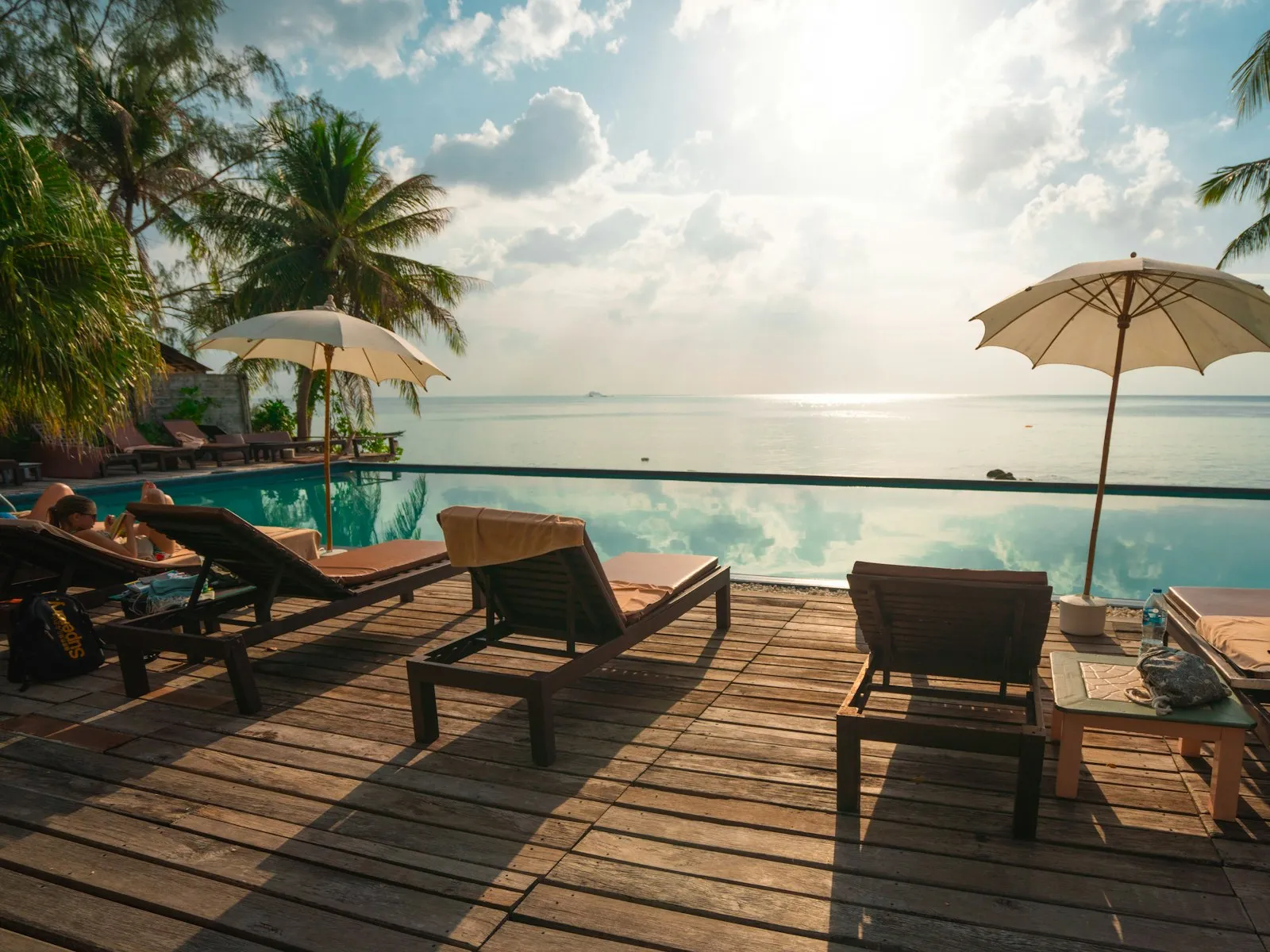 Ocean Suite — Floor-to-ceiling glass frames an uninterrupted horizon.